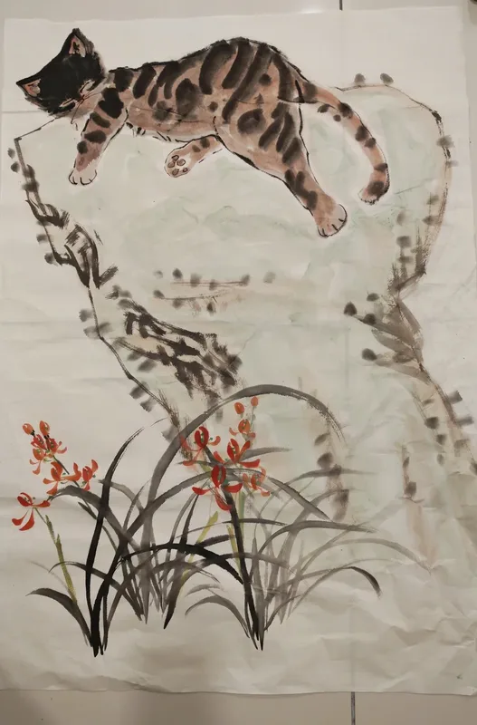 Ink painting: a cat stretched along a rock above red orchids