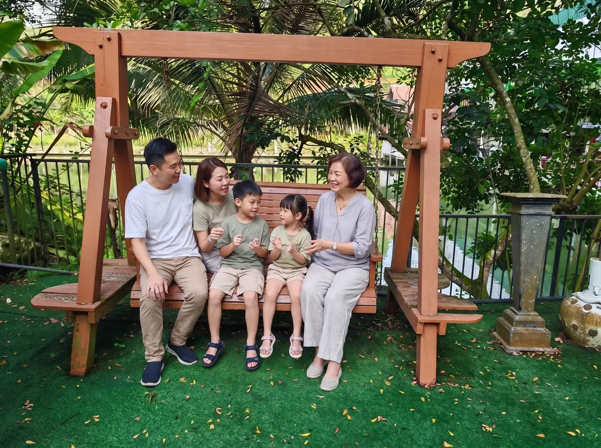 A family on the swing by the lake
