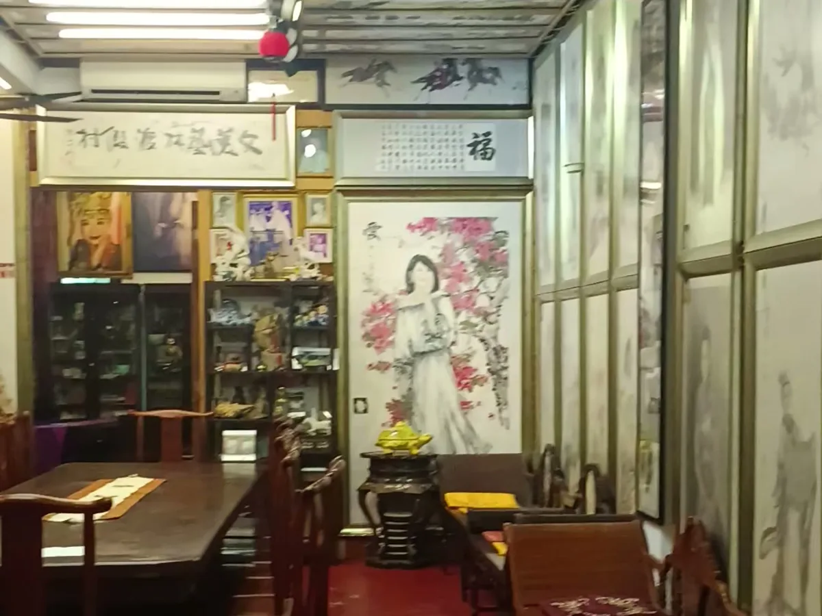 The gallery hall: the long rosewood table, paintings and calligraphy on every wall, the red carpet