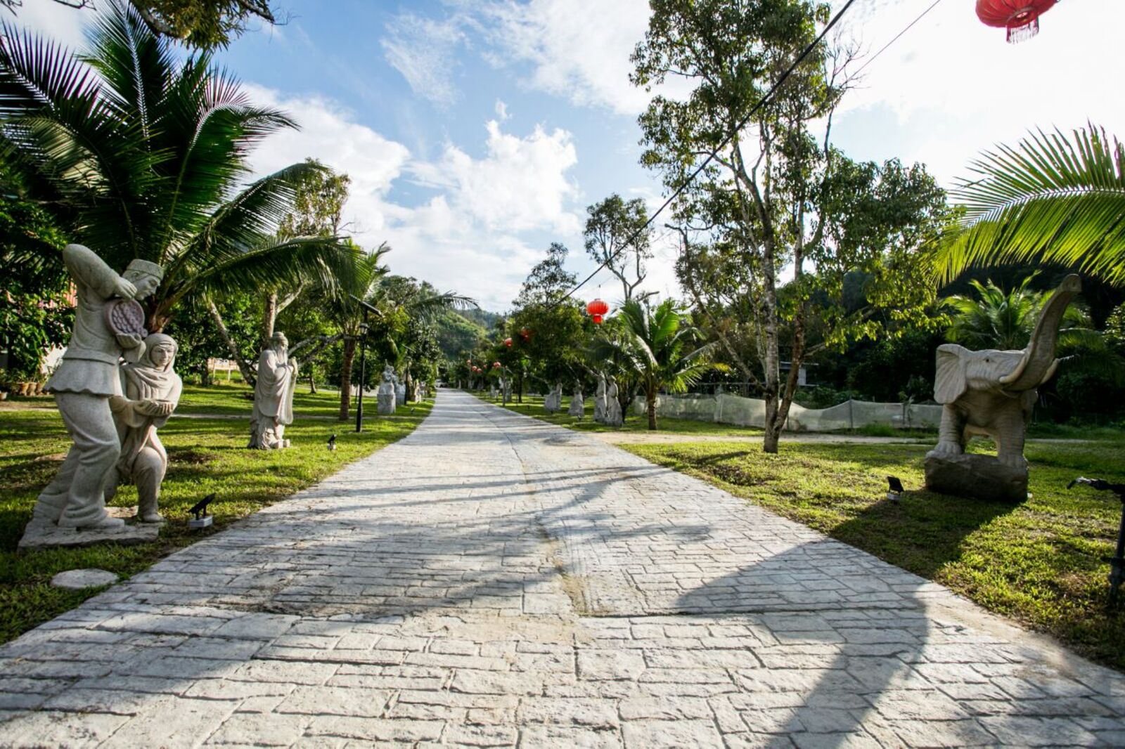 Sculpture trail path with stone statues and red lanterns